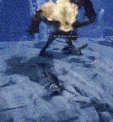 a person is standing on a snowy surface with a flame coming out of their hand