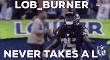 a football player is running on the field with a sign that says lob burner never takes a l .