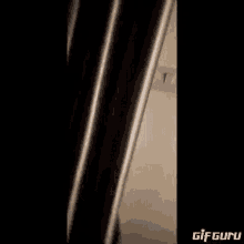 a close up of a person walking down stairs with a black background .