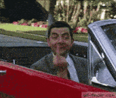 a man in a suit and tie is giving the middle finger