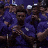 a group of men wearing purple lsu polo shirts