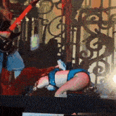a man playing a guitar and a woman laying on the stage
