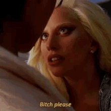 a woman with blonde hair is talking to a man and says bitch please .