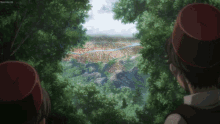 two people wearing red hats are looking out over a valley