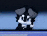 a black and white cartoon character is standing in front of a computer screen .
