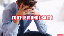 a man covering his face with his hands and the words tout le monde sait written below him