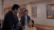 a woman in a wheelchair is talking to a man in a room .