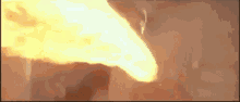 a close up of a person 's face with flames coming out of it 's mouth .