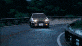 a car is driving down a road at night and has a license plate that says y9322
