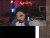a man wearing headphones is sitting in front of a computer