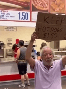 a man holding up a sign that says keep hotdogs 1.50