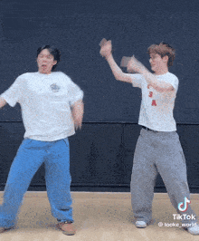 two men are dancing together and one has a shirt that says usa