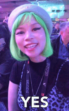 a woman wearing a green wig and a leopard print shirt says yes