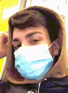 a pixelated image of a man wearing a mask and a hoodie