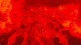 a man is surrounded by red flames in a dark room in a video game .