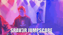 a dj is playing music in a dark room with the words srav3r jumpscare above him .