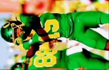 a football player in a green uniform with the number 8 on it