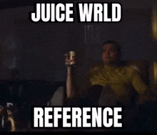 a man sitting on a couch with juice wrld reference written on the screen