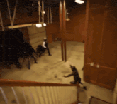 a group of people are standing in a room with a door that says ' exit ' on it