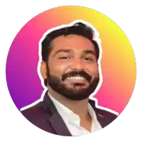 a man with a beard is smiling in front of a pink and yellow background