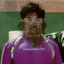 a man in a purple monster xian shirt