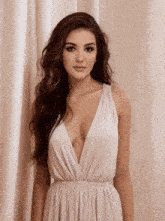 a woman in a white dress has a very plunging neckline