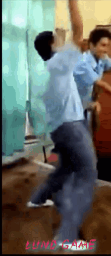 a man in a blue shirt is jumping in the air with the words lund game written below him