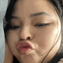 a close up of a woman making a face with her mouth open