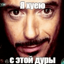 a close up of a man 's face with a mustache and a meme in russian .