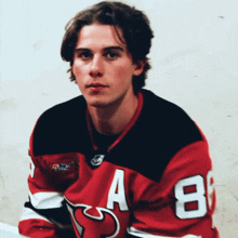 a hockey player wearing a red jersey with the number 8 on it