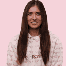 a woman wearing a hismile hoodie smiles for the camera