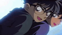two anime characters are hugging each other and one is wearing glasses .