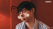 a man with a cat face drawn on his face