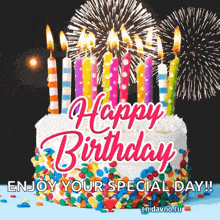 a birthday cake with candles and fireworks in the background