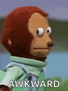 a stuffed monkey with the word awkward written on the bottom