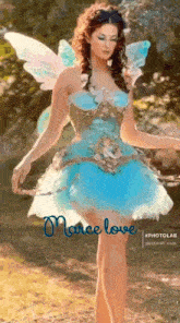 a woman in a blue fairy costume is standing in a field