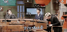 a group of men are sitting around a table with a sign that says 15 on it