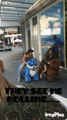 a woman riding a stuffed animal that says they see me rolling on it