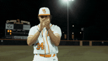 a baseball player with the number 34 on his jersey is clapping
