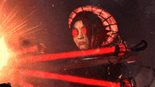 a man with red eyes is holding a red light