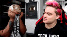 a man with pink hair and a shirt that says good days