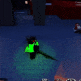 a person in a green shirt is standing in a dark room