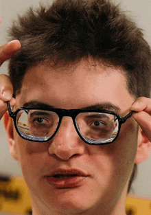 a close up of a person wearing glasses with a reflection