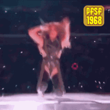 a woman is dancing on a stage with a pfsf 1968 sticker behind her