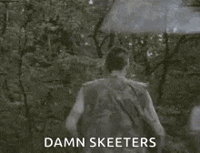 a man is walking through a forest with an umbrella and says `` damn skeeeters '' .