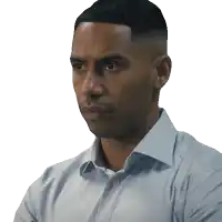 a man in a light blue shirt is looking to his left