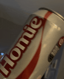 a close up of a can of coca cola with the word homie on it