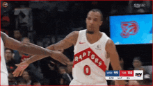 a basketball player with the number 0 on his jersey reaches out to shake another player 's hand