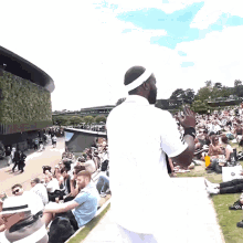 a man wearing a headband is standing in front of a crowd