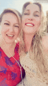 two women are posing for a picture with a starmaker logo in the background